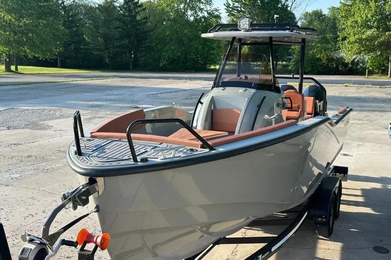 Slide: The Image of 2020 Dromeas D28 CC boat on trailer, parked outdoors, surrounded by trees. - 1