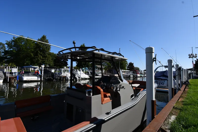 Slide: The Image of 2020 Dromeas D28 CC boat docked at a marina under clear blue skies. - 1