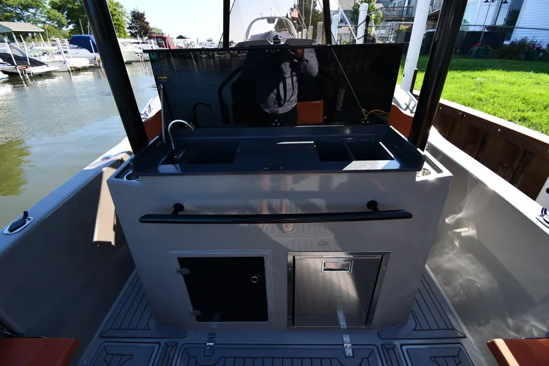 Slide: The Image of 2020 Dromeas D28 CC boat interior with kitchenette and sink, docked at marina. - 16