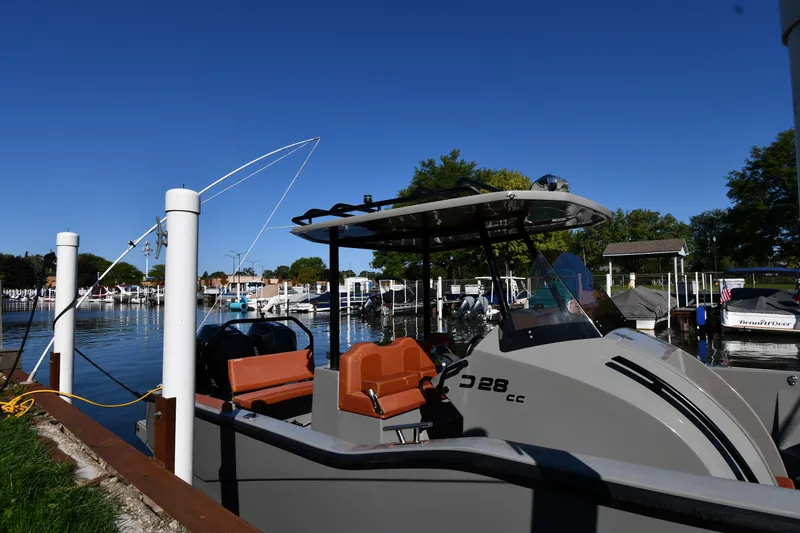 Slide: The Image of 2020 Dromeas D28 CC boat docked at a marina under clear blue skies. - 2