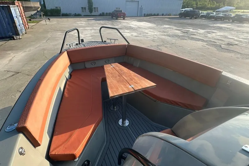 Slide: The Image of 2020 Dromeas D28 CC boat interior with orange seating and wooden table. - 7