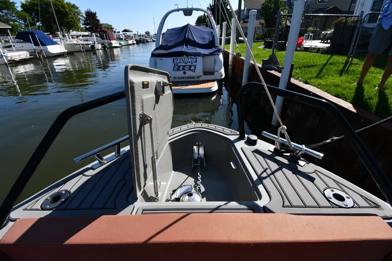 Slide: The Image of 2020 Dromeas D28 CC boat docked in a marina, showcasing its bow and anchor. - 4