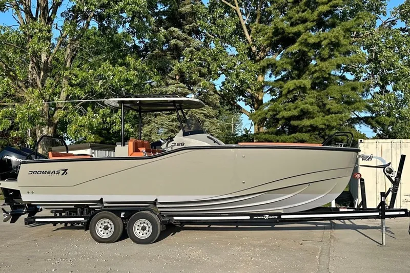 The Image of 2020 Dromeas D28 CC boat on trailer, surrounded by trees. - 0