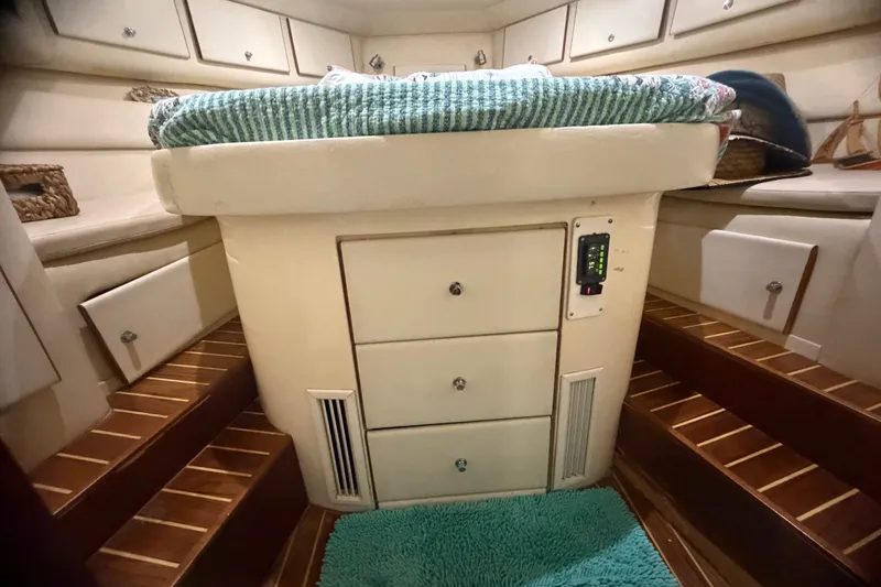 Slide: The Image of Interior of 1999 Phoenix 38 SFX Convertible boat with wooden steps and storage drawers. - 44
