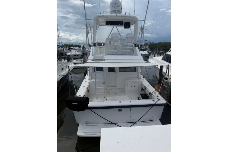 Slide: The Image of 1999 Phoenix 38 SFX Convertible yacht docked at marina, rear view. - 5