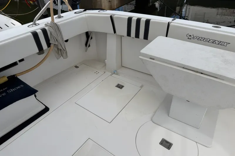 Slide: The Image of 1999 Phoenix 38 SFX Convertible boat deck with seating and storage compartments. - 12