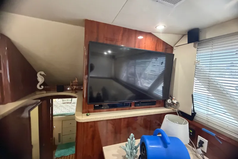 Slide: The Image of Interior of 1999 Phoenix 38 SFX Convertible with TV and nautical decor. - 31