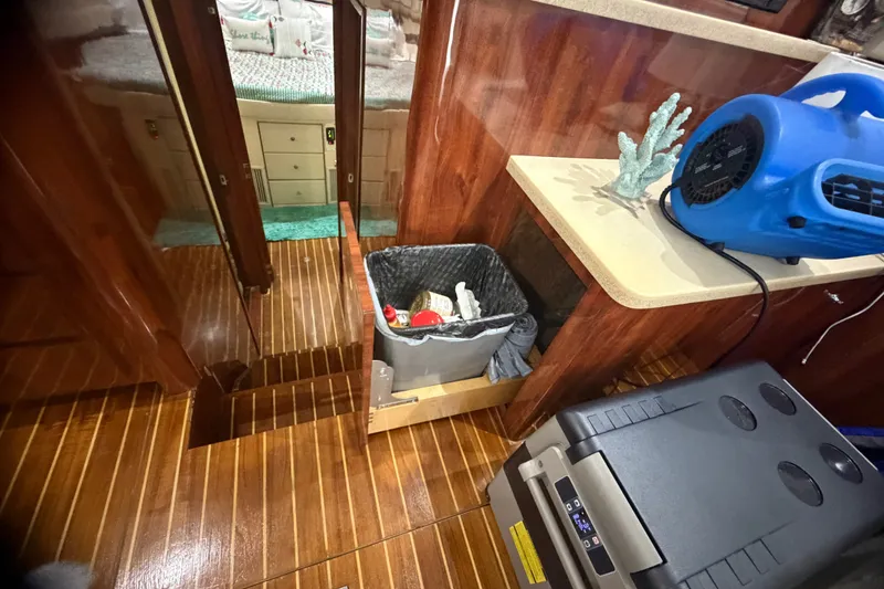 Slide: The Image of Interior of 1999 Phoenix 38 SFX Convertible yacht with wood flooring and modern amenities. - 33