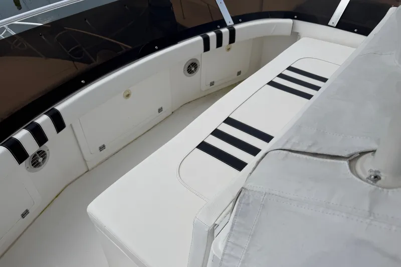 Slide: The Image of 1999 Phoenix 38 SFX Convertible boat interior with white seating and black accents. - 54