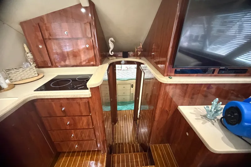 Slide: The Image of Luxurious interior of 1999 Phoenix 38 SFX Convertible yacht with polished wood and modern amenities. - 42