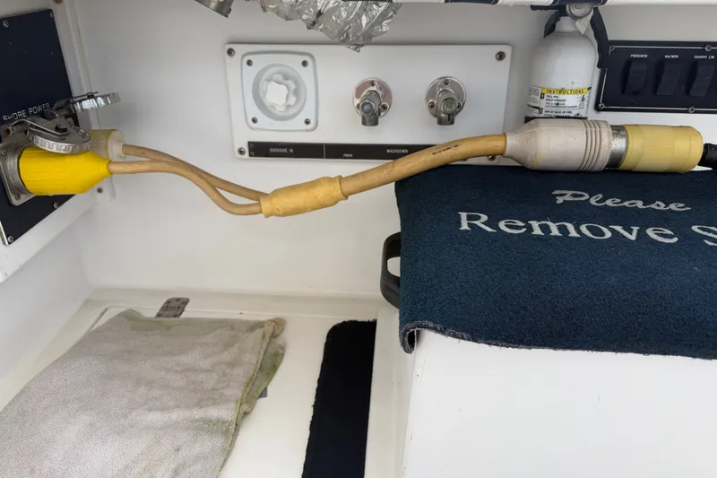 Slide: The Image of Electrical connections and safety equipment on a 1999 Phoenix 38 SFX Convertible boat. - 13