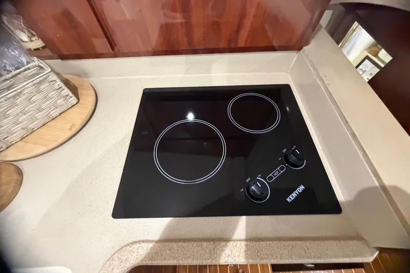 Slide: The Image of Kenyon electric cooktop in 1999 Phoenix 38 SFX Convertible yacht kitchen. - 40