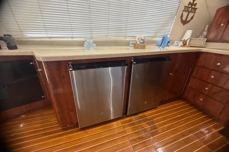 Slide: The Image of Luxurious kitchen interior of 1999 Phoenix 38 SFX Convertible yacht with stainless steel appliances. - 30