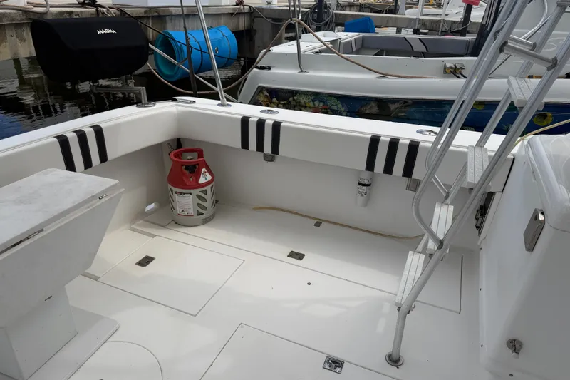 Slide: The Image of 1999 Phoenix 38 SFX Convertible boat deck with ladder and propane tank. - 11