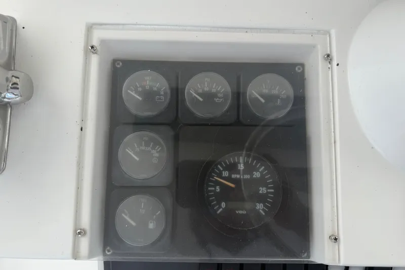 Slide: The Image of Instrument panel of a 1999 Phoenix 38 SFX Convertible boat, displaying various gauges. - 63