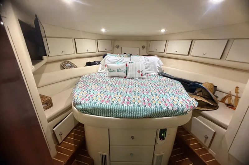 Slide: The Image of Cozy cabin interior of 1999 Phoenix 38 SFX Convertible with colorful bedding and ample storage. - 43