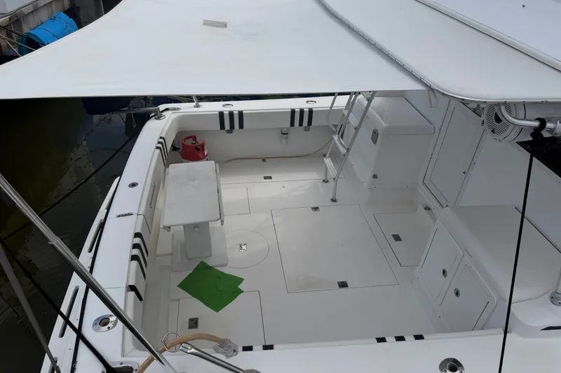Slide: The Image of Spacious deck of a 1999 Phoenix 38 SFX Convertible boat with canopy and seating. - 9