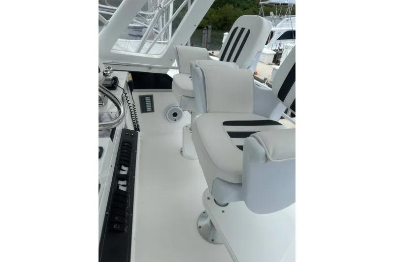 Slide: The Image of Interior of 1999 Phoenix 38 SFX Convertible yacht with white and black seating. - 70
