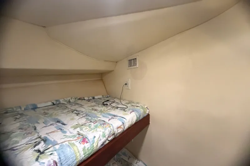 Slide: The Image of Cozy cabin interior of 1999 Phoenix 38 SFX Convertible with patterned bedding. - 50