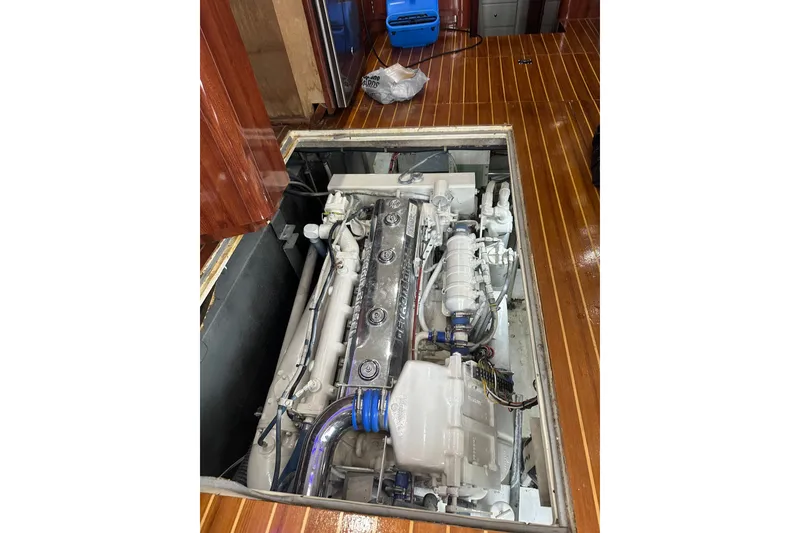 Slide: The Image of Engine compartment of a 1999 Phoenix 38 SFX Convertible yacht with visible machinery. - 67