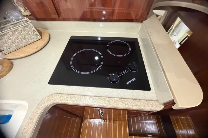 Slide: The Image of Kenyon electric cooktop in 1999 Phoenix 38 SFX Convertible yacht kitchen. - 36