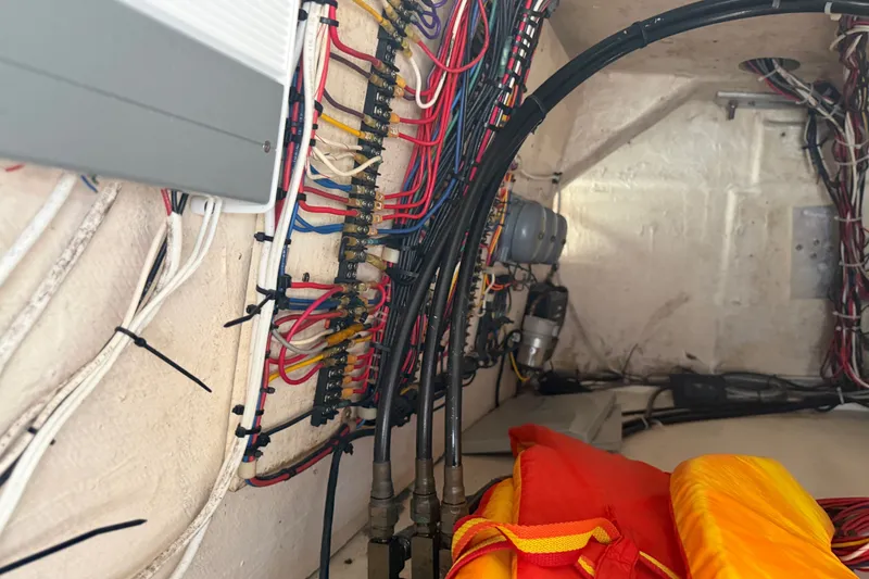Slide: The Image of Electrical wiring and equipment inside a 1999 Phoenix 38 SFX Convertible boat. - 66