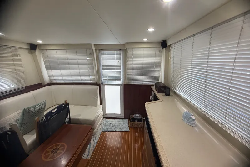 Slide: The Image of Interior of 1999 Phoenix 38 SFX Convertible yacht with cozy seating and wooden flooring. - 37