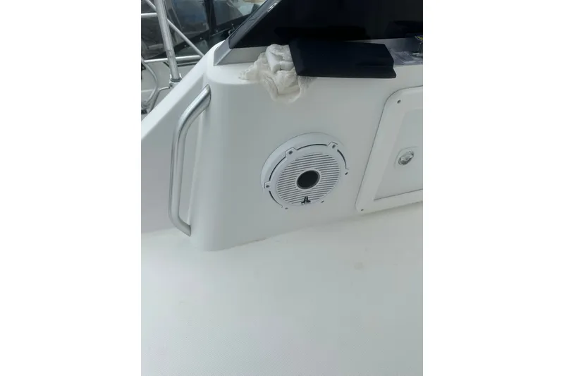 Slide: The Image of 1999 Phoenix 38 SFX Convertible boat interior with speaker and railing. - 69
