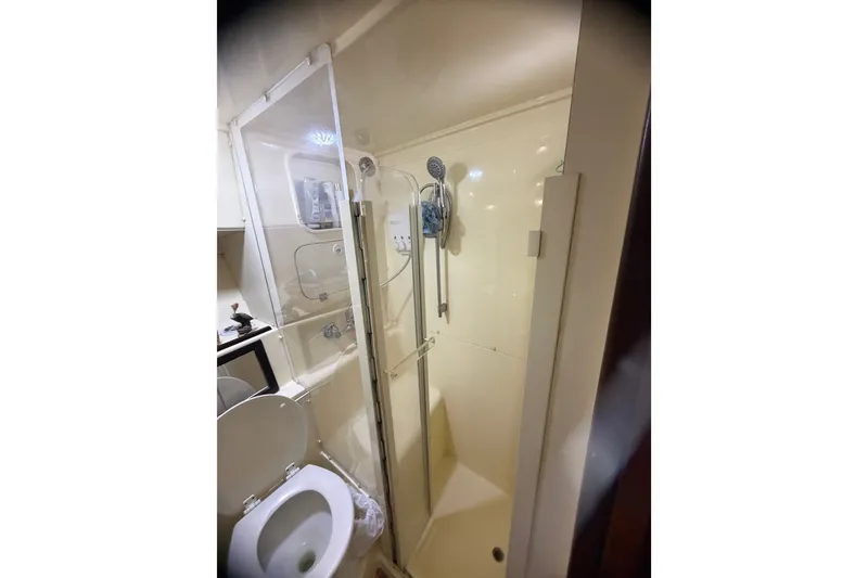 Slide: The Image of Bathroom with shower in 1999 Phoenix 38 SFX Convertible yacht. - 52