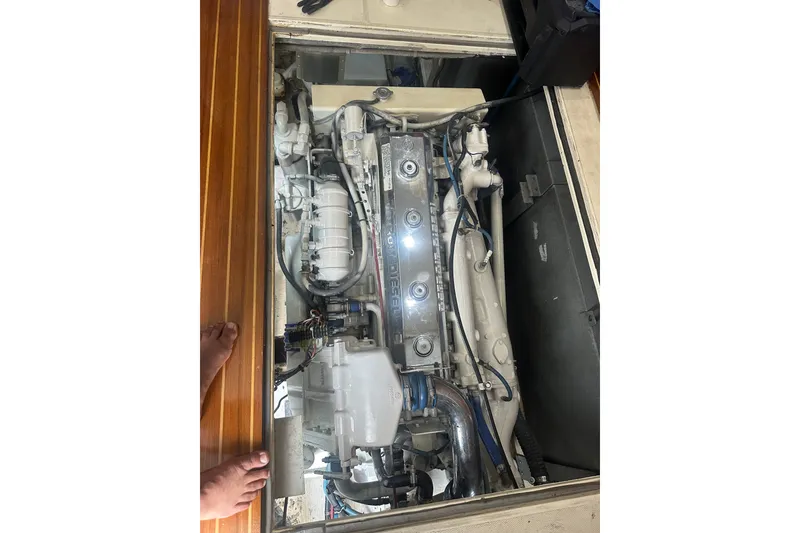 Slide: The Image of Engine compartment of a 1999 Phoenix 38 SFX Convertible boat, showcasing detailed machinery. - 68