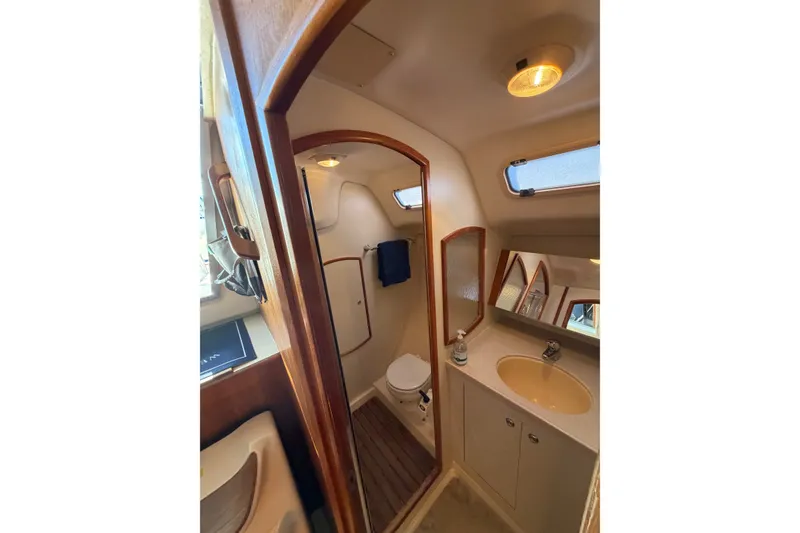 Slide: The Image of Compact bathroom in 2002 Hunter 356 sailboat with wooden accents and modern fixtures. - 36