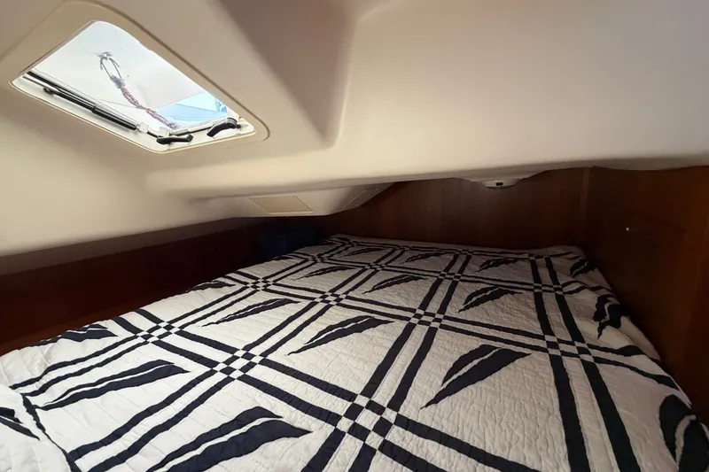Slide: The Image of Cozy cabin interior of 2002 Hunter 356 sailboat with patterned bedding and overhead hatch. - 40