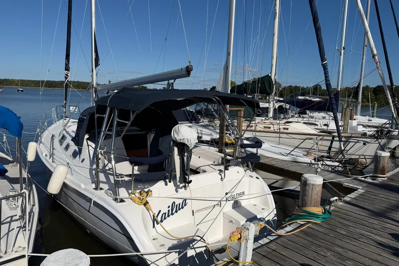 Slide: The Image of Hunter 356 sailboat from 2002 docked at a marina under clear blue skies. - 4
