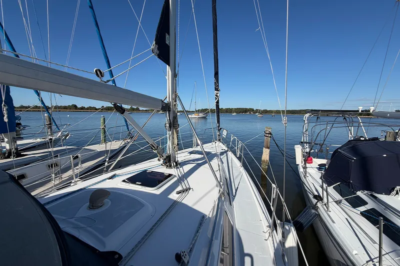 Slide: The Image of Sailboat docked on calm water, Hunter 356 model, 2002, under clear blue sky. - 6