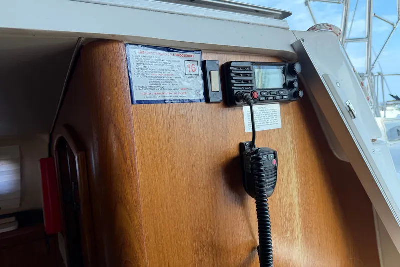 Slide: The Image of Interior of a 2002 Hunter 356 sailboat featuring a mounted radio communication system. - 21
