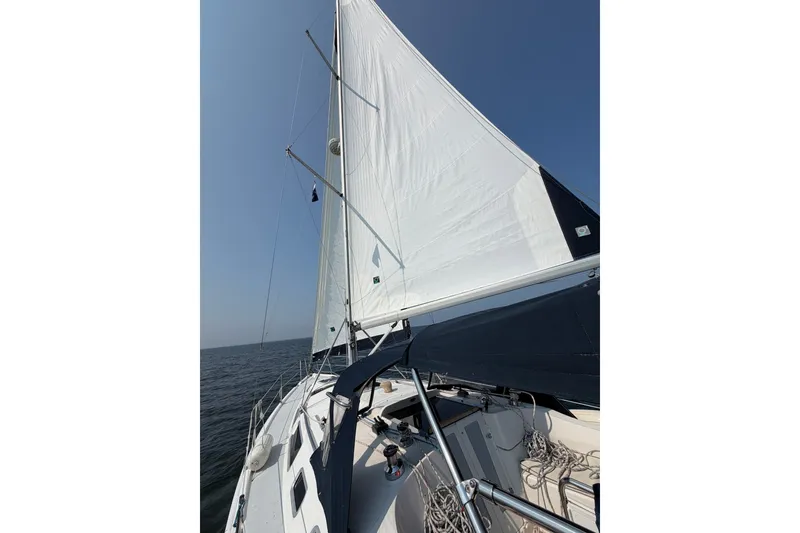 Slide: The Image of Sailing on a 2002 Hunter 356 yacht with white sails against a clear blue sky. - 2