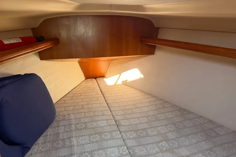 Slide: The Image of Cozy cabin interior of 2002 Hunter 356 sailboat with patterned bedding and wooden accents. - 43