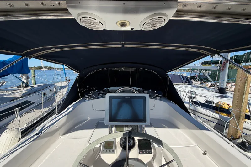 Slide: The Image of Cockpit view of a 2002 Hunter 356 sailboat with navigation equipment and canopy. - 13