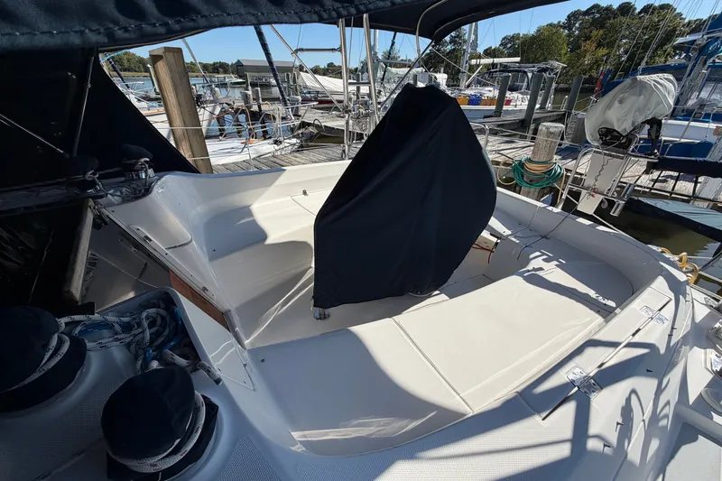 Slide: The Image of 2002 Hunter 356 sailboat cockpit with covered helm, docked at marina. - 12