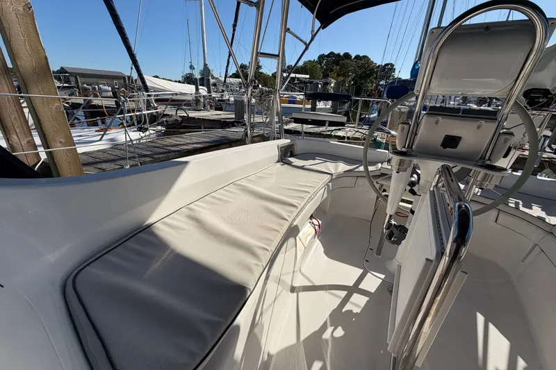Slide: The Image of Cockpit of a 2002 Hunter 356 sailboat with steering wheel and seating area. - 17