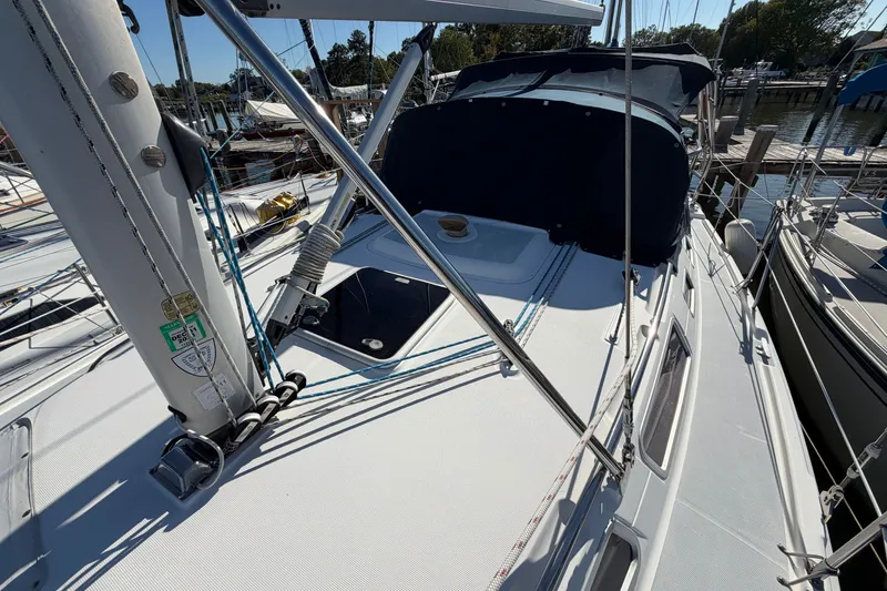 Slide: The Image of 2002 Hunter 356 sailboat deck with rigging and canopy in marina setting. - 9