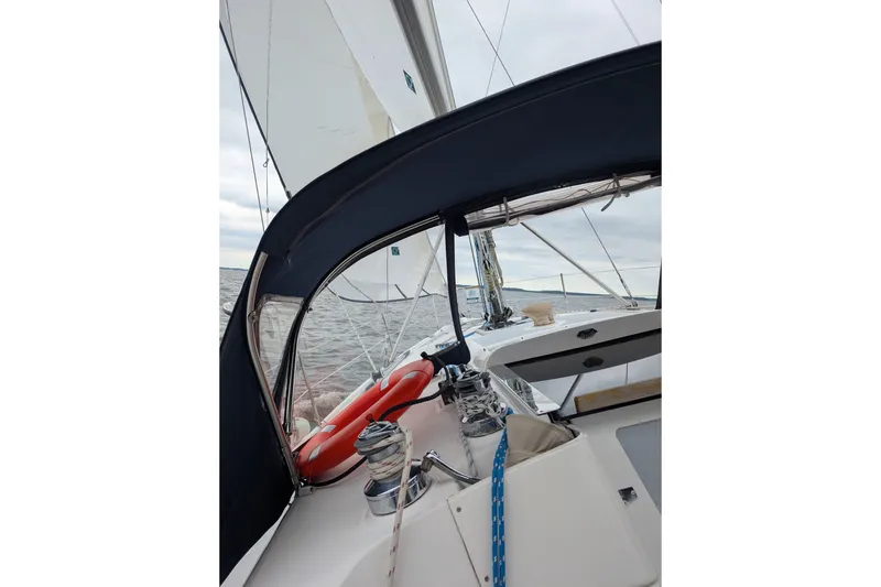 Slide: The Image of 2002 Hunter 356 sailboat cockpit with life preserver and ocean view. - 1
