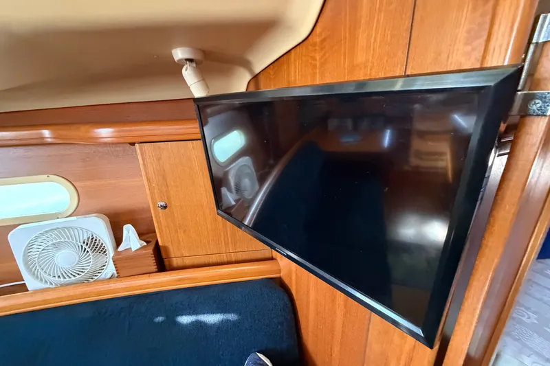 Slide: The Image of Interior of a 2002 Hunter 356 yacht with mounted TV and fan. - 34