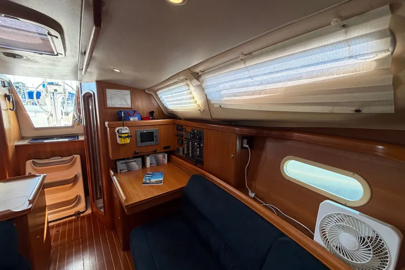 Slide: The Image of Interior of a 2002 Hunter 356 sailboat with wood paneling and navigation equipment. - 33