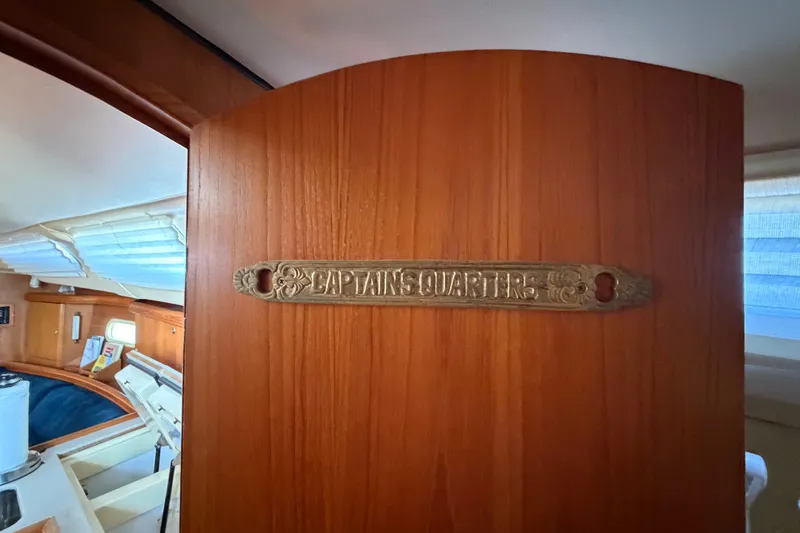 Slide: The Image of Wooden door with "Captain's Quarters" plaque on a 2002 Hunter 356 sailboat. - 38