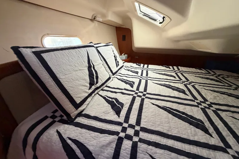 Slide: The Image of Cozy cabin interior of 2002 Hunter 356 sailboat with patterned bedding and natural light. - 39
