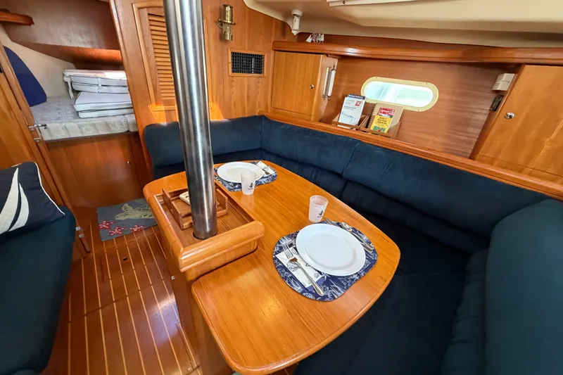 Slide: The Image of Interior of 2002 Hunter 356 sailboat with cozy dining area and wooden finishes. - 30