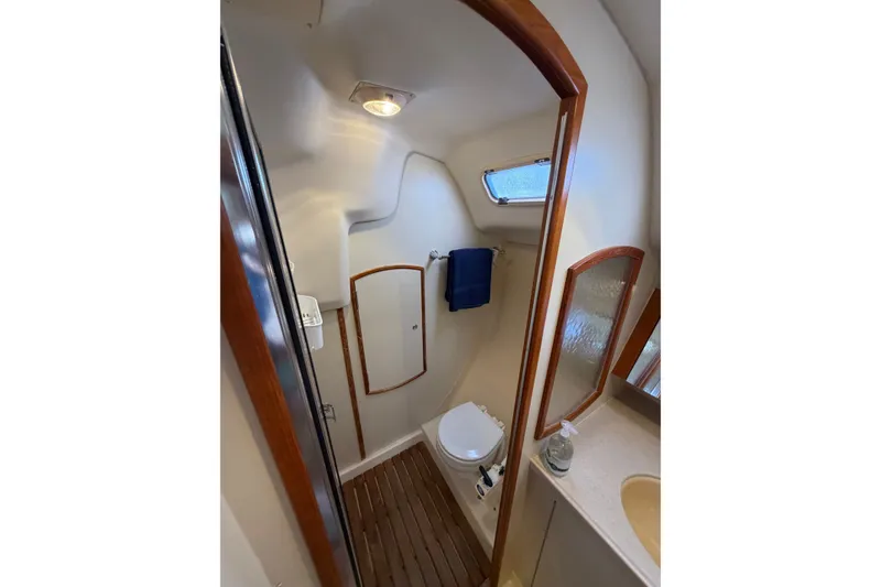 Slide: The Image of Compact bathroom in 2002 Hunter 356 sailboat with wooden accents and modern fixtures. - 35