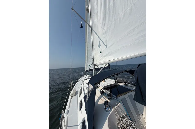 Slide: The Image of Sailing on a 2002 Hunter 356 yacht with white sails against a clear blue sky. - 3