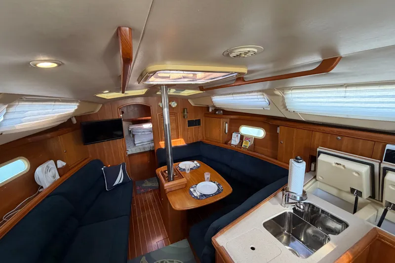 Slide: The Image of Interior of a 2002 Hunter 356 sailboat with cozy seating and kitchenette. - 28